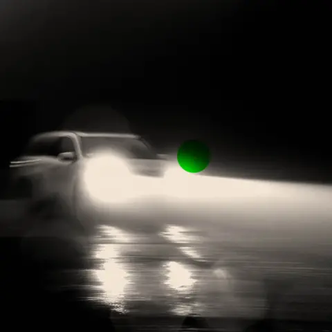 BBC A treated image of a car driving at night with its headlights on