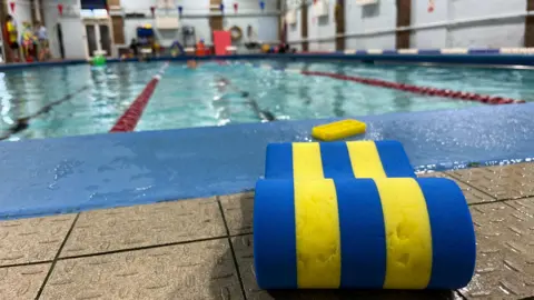 George Carden/BBC The swimming pool with a float on the pool side.