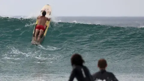Reuters/Tom Nicholson An RNLI Lifeguard uses a rescue board during hot weather at Perranporth beach, in Perranporth, Cornwall.