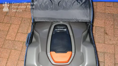 COPFS Compact robot mower with orange stop button inside fabric bag