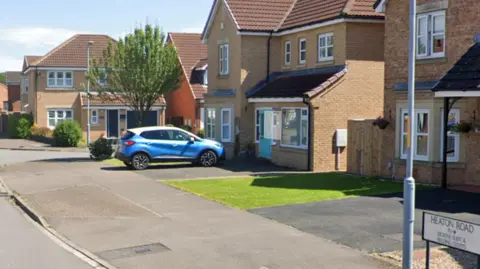 Google Heaton Street, one of the roads where accelerants were poured on to vehicles or properties. The road sign can be seen in the bottom right of the picture. It is a relatively new build estate of detached houses.