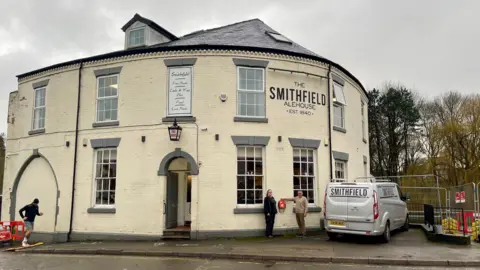A white painted brick two-storey building