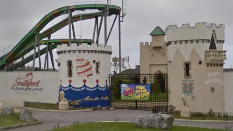 Google Entrance to Southport Pleasure beach with two turrets and a log flume ride in the background