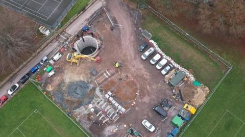 Aerial view of the tank - a large concreted hole with building site around it