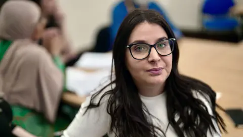 BBC Cintia, a social worker, in the office where she has received additional training 