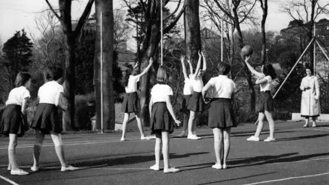 Beaulieu Convent School Jersey Black and white photo of girls playing netball