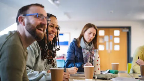 Adults in a classroom learning Welsh though The National Centre for Learning Welsh 