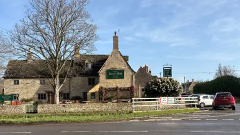 Mason's Arms in Clanfield is a large Cotswold stone building.