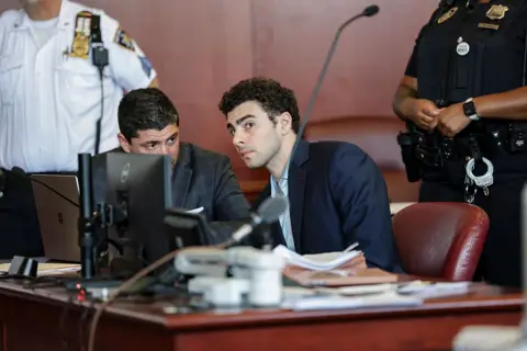Luigi Mangione speaks with his lawyer during a court hearing in New York on 18 May 2026.