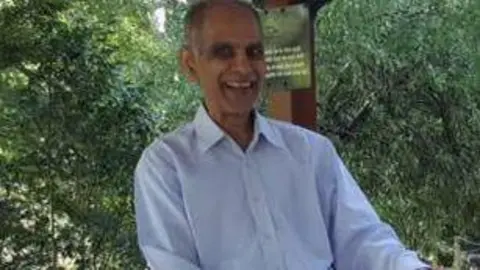 Facebook Bhim Kohli wearing a light-coloured shirt with trees in the background