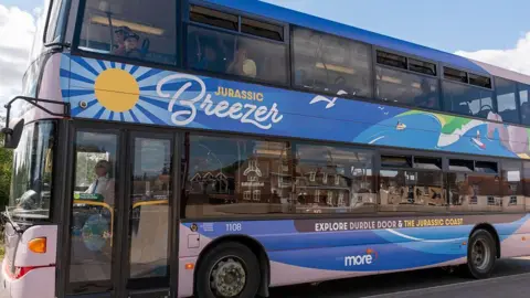 Blue branded jurassic breezer bus
