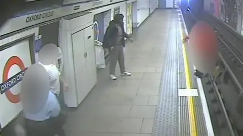 Met Police A still from CCTV footage of the moment Tadeusz Potoczek was pushed off the platform