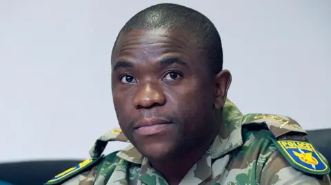 Nhlanhla Mkhwanazi is seen wearing military-like police uniform during a briefing