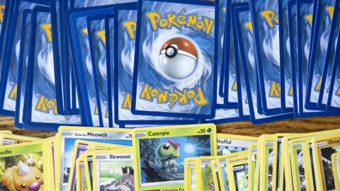 Getty Images A row of rear facing Pokémon cards with a row of front facing cards beneath
