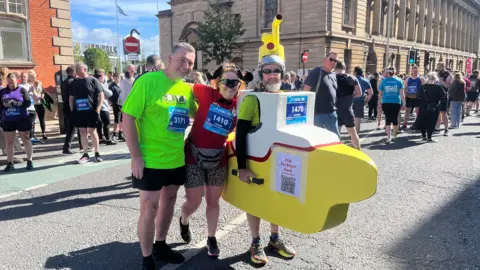 BBC Runners Carl Procter, Louise Greave and Kevin Blacker in his yellow submarine