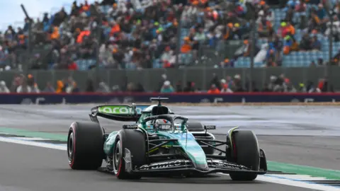 Getty Images Aston martin Aramco car on the Silverstone F1 circuit backed by a stand of cheering fans