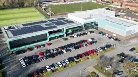 North Yorkshire Council An overhead view of the leisure centre showing a large car park, rugby and football fields