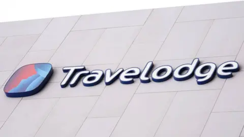 PA Media A sign for hotel chain Travelodge.