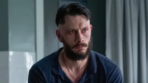 Richard Gadd looks morose while sitting in a hospital in his new TV series Half Man