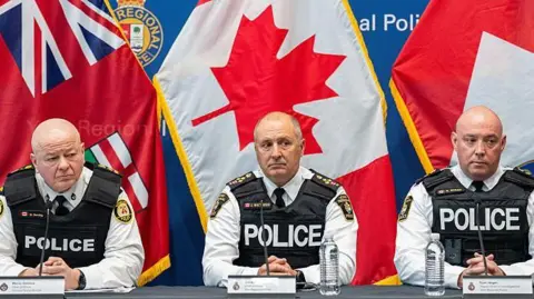 Three police officials brief reporters at a press conference