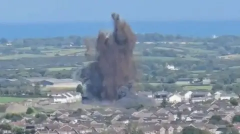 Explosion in Newtownards, County Down, large black flume above housing estate