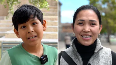 On the left, a boy in a green shirt. On the right, a woman in a grey shirt. 