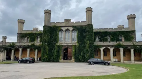 BBC The exterior of Lincoln Crown Court with greenery growing up the walls, columns and turrets