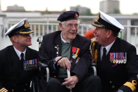 PA (left to right) Royal Navy Commander Glen Hickson, D-Day veteran Jim Grant and Royal Navy Commodore John Voyce