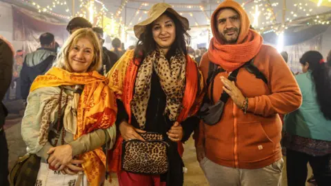 Millions begin bathing in sacred rivers during Hindu festivals in India 50 Ankit Srinivas Sebastian Diago (right) is visiting as part of a 90-member group from Argentina.