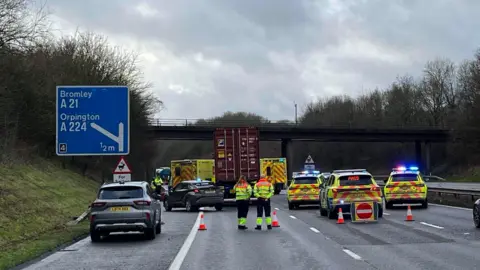 Police and an ambulance at the scene of the crash on the M25