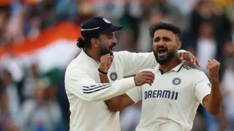 Akash Deep celebrates a wicket with KL Rahul, left