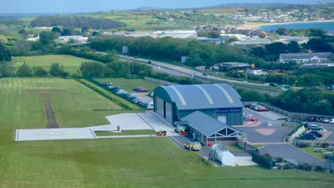 Penzance Helicopters The heliport showing it's closeness to roads and other industry buildings in the background.