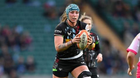 Danelle Loch runs with the ball during a game for Harlequins