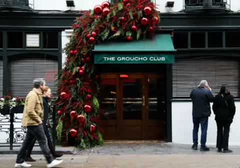 The entrance of the Groucho Club dressed up in a festive way with baubles 