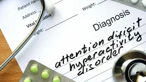 Getty Images A form with a diagnosis for attention deficit hyperactivity disorder and tablets. 