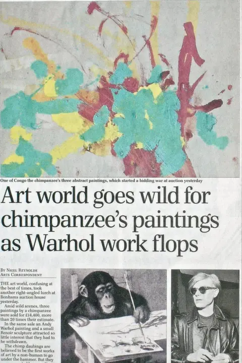 Getty Images Newspaper article about Congo's paintings. The headline is "Art World goes wild for chimpanzee's paintings as Warhol work flops".  There is a photo of both a chimp painting and the artist Andy Warhol and a colour picture of the chimps splashes of paint