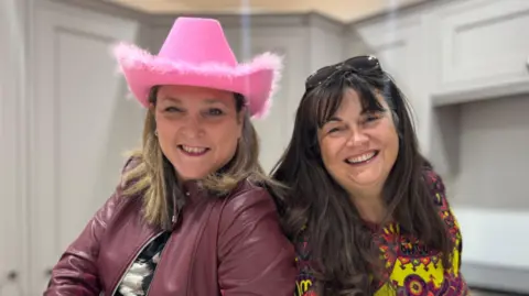 Supplied Janine Holmes, CEO of the Derbyshire Children's Holiday Centre (left) with Kerry Anderson (right)