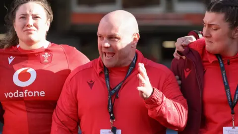 Sean Lynn animatedly talks to players