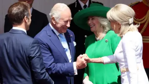 Reuters The French presidential couple is greeted by King Charles and Queen Camilla in Windsor.