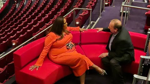 TV presenter Alison Hammond sitting on the red sofa with Ben Sidwell at Birmingham Hippodrome