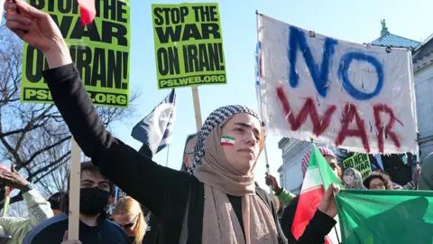 AFP via Getty Images People condemn the attack on Iran during a protest in Washington DC on 28 February 2026