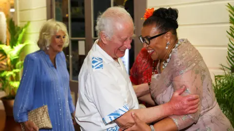 Reuters King Charles and Commonwealth Secretary General Patricia Scotland laugh as they embrace. 