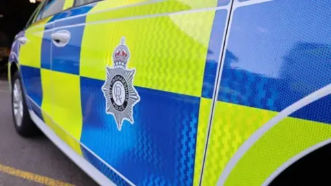 A police car with an image of the Nottinghamshire Police badge
