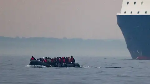 Getty Images People ride in a boat across the English Channel