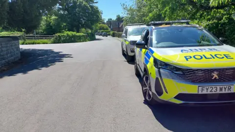 Matlock, Cromford, Wirksworth and Darley Dale Police SNT Two police vehicles outside a school