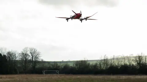 Drone is shown hoovering above the ground as it takes off for a demonstration flight