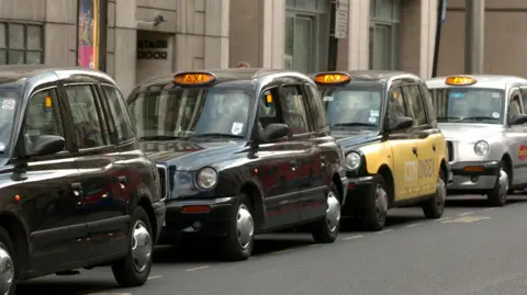 Ian Nicholson/PA Media Hackney carriages or London taxis ("Black Cabs") wait on a cab rank at Victoria Station 