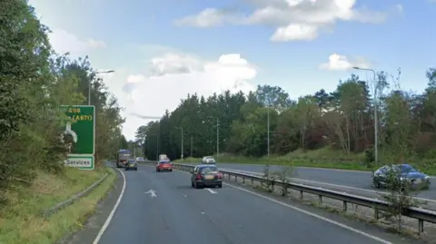 A screenshot from Google showing the A59 between the A671 and Holm Road in Barrow, with cars and trees and a sign saying Clitheroe and Services.