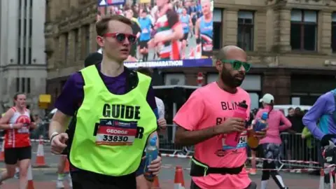 BBC Blind man Yahya Pandor running the Manchester Marathon with vocal assistance from his guide