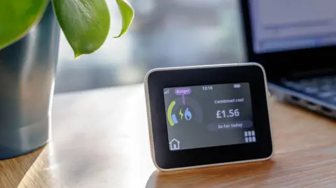 Getty Images A stock image of a smart meter screen. It is a small box with a diagram of spending on the screen. A blue flame, indicating heating or gas usage can be seen on the left and a combined cost logo is on the right side. £1.56 so far today is showing currently.